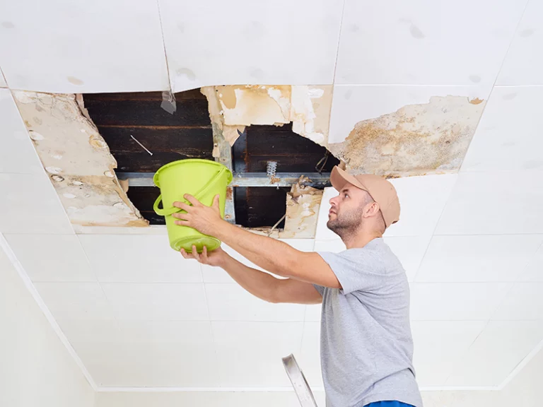 Flood and Water Damage Restoration in Palm Shores, Florida - photo of a man holding a bucket to a water leak